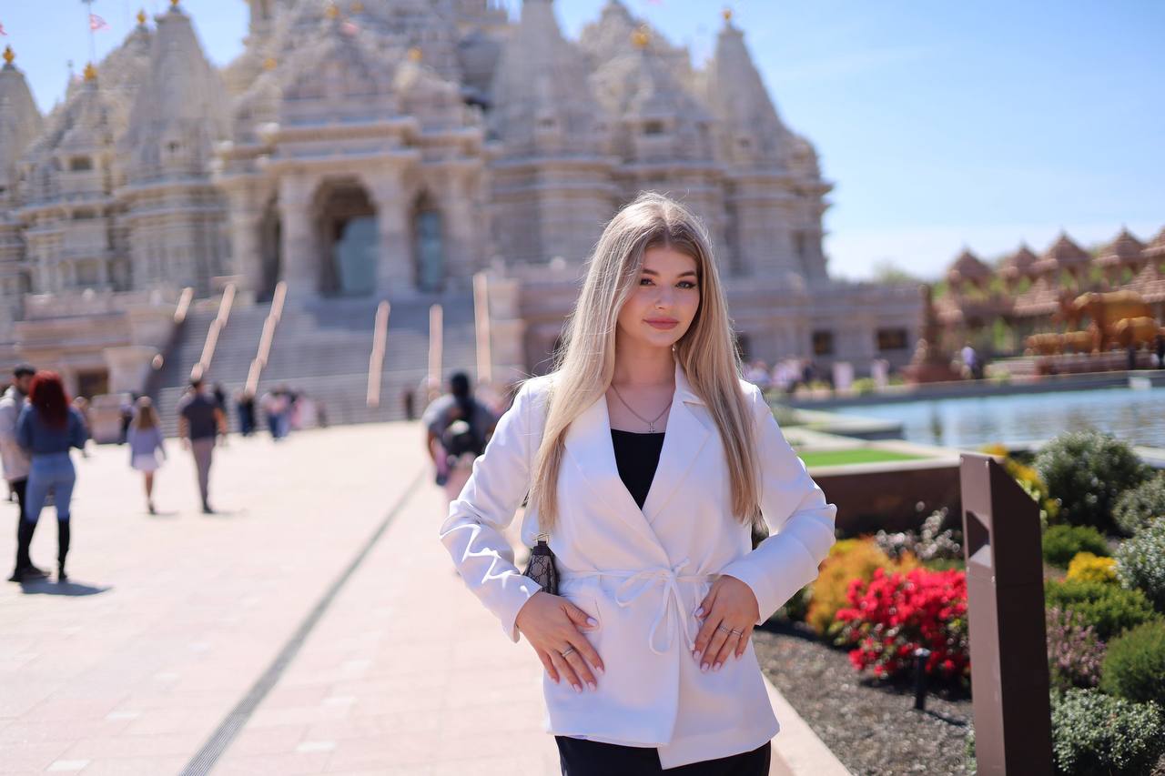 Hands-on-hips portrait at white marble temple